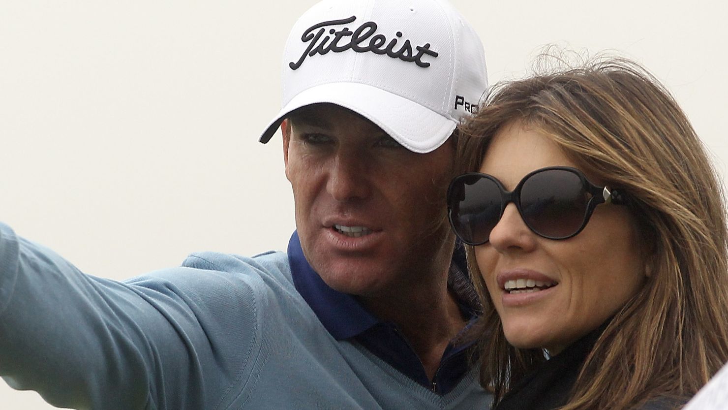 Shane Warne and Elizabeth Hurley watch the action during the third round of The Alfred Dunhill Links Championship.