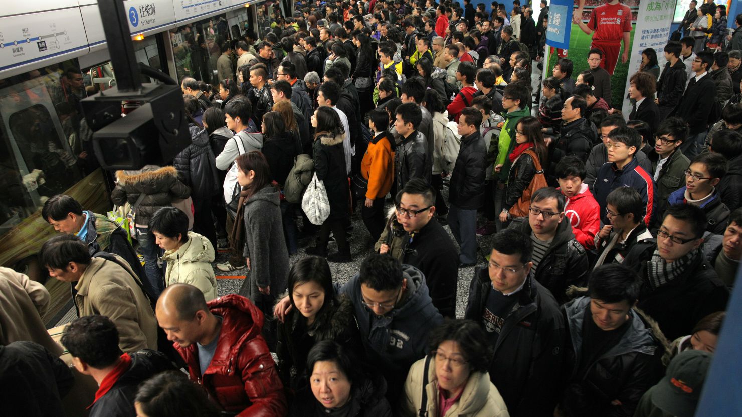Travellers prepare to board a mass transit railway (MTR) train in Hong Kong on January 29.