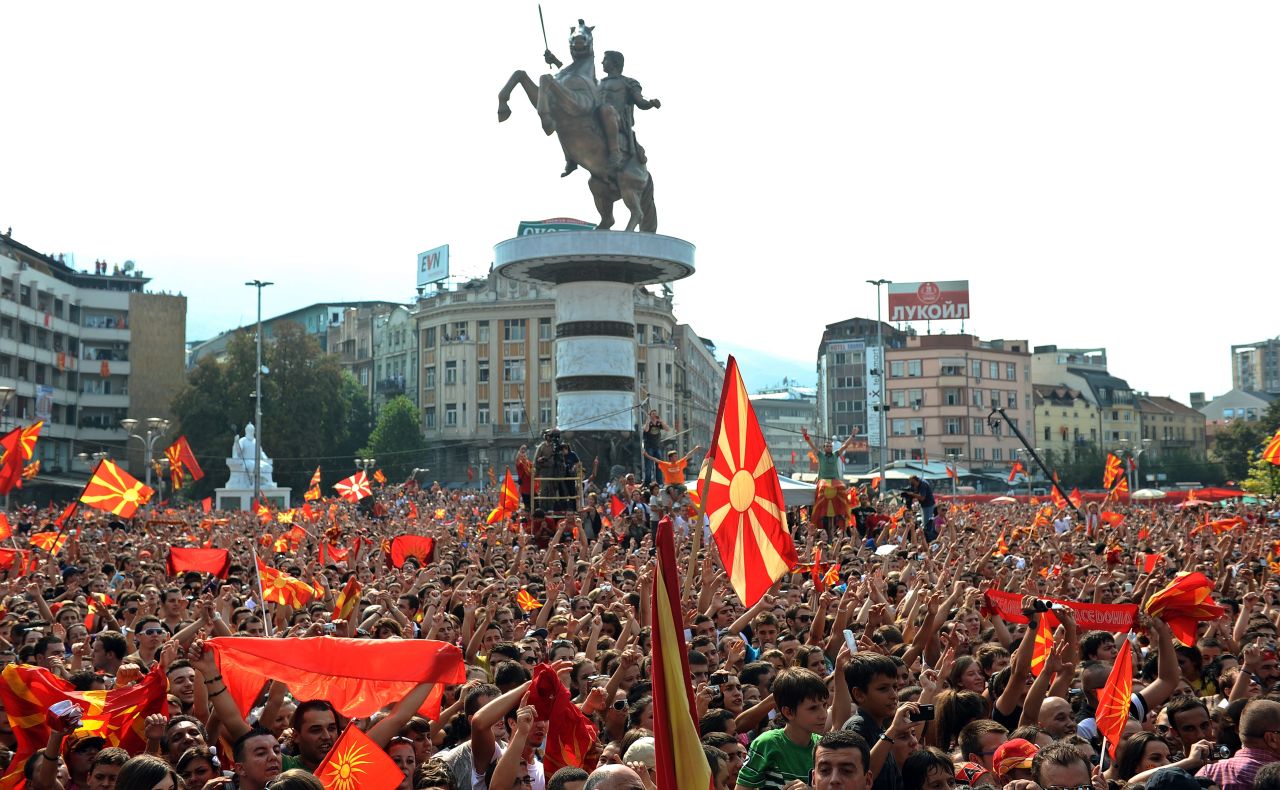 Crowds celebrate the European success of the Macedonian national basketball team in front of the new Warrior on a Horse statue in Skopje's main square.