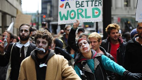 Demonstrators with "Occupy Wall Street" participate in a march dressed as "corporate zombies" in New York on Monday, October 3.