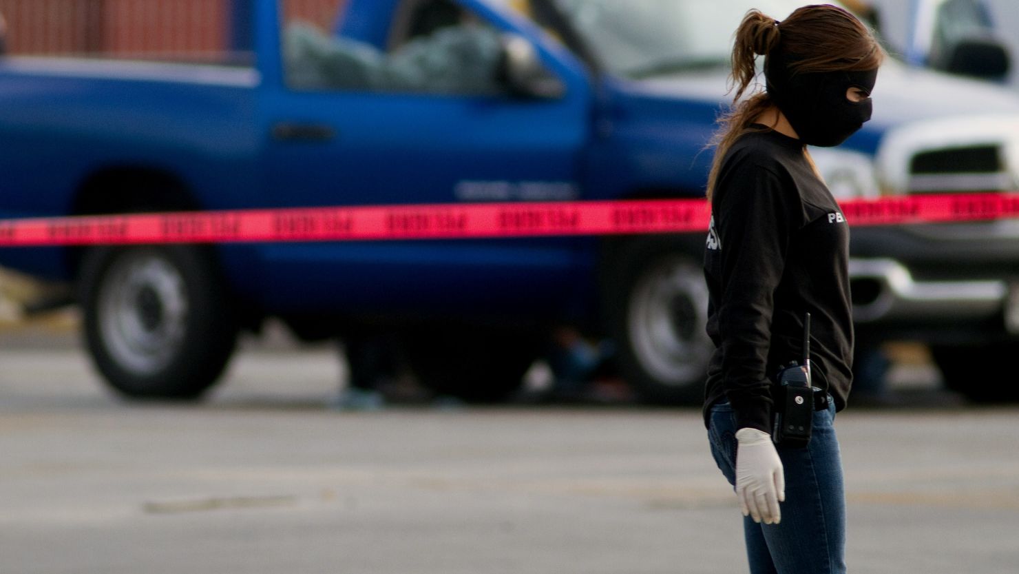A member of Mexico's Ministerial Police investigates the scene of a murder in Ciudad Juarez on December 6, 2010. FILE