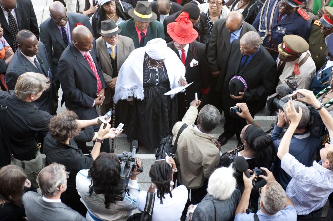 Members of the Namibian delegation read a prayer outside Berlin's Charite University Hospital before the ceremony.