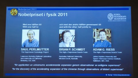 A giant screen in Stockholm shows the joint winners of the Nobel Prize in physics for 2011.