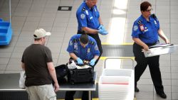 A TSA agent checks a bag on May 2, 2011, at Orlando International Airport.