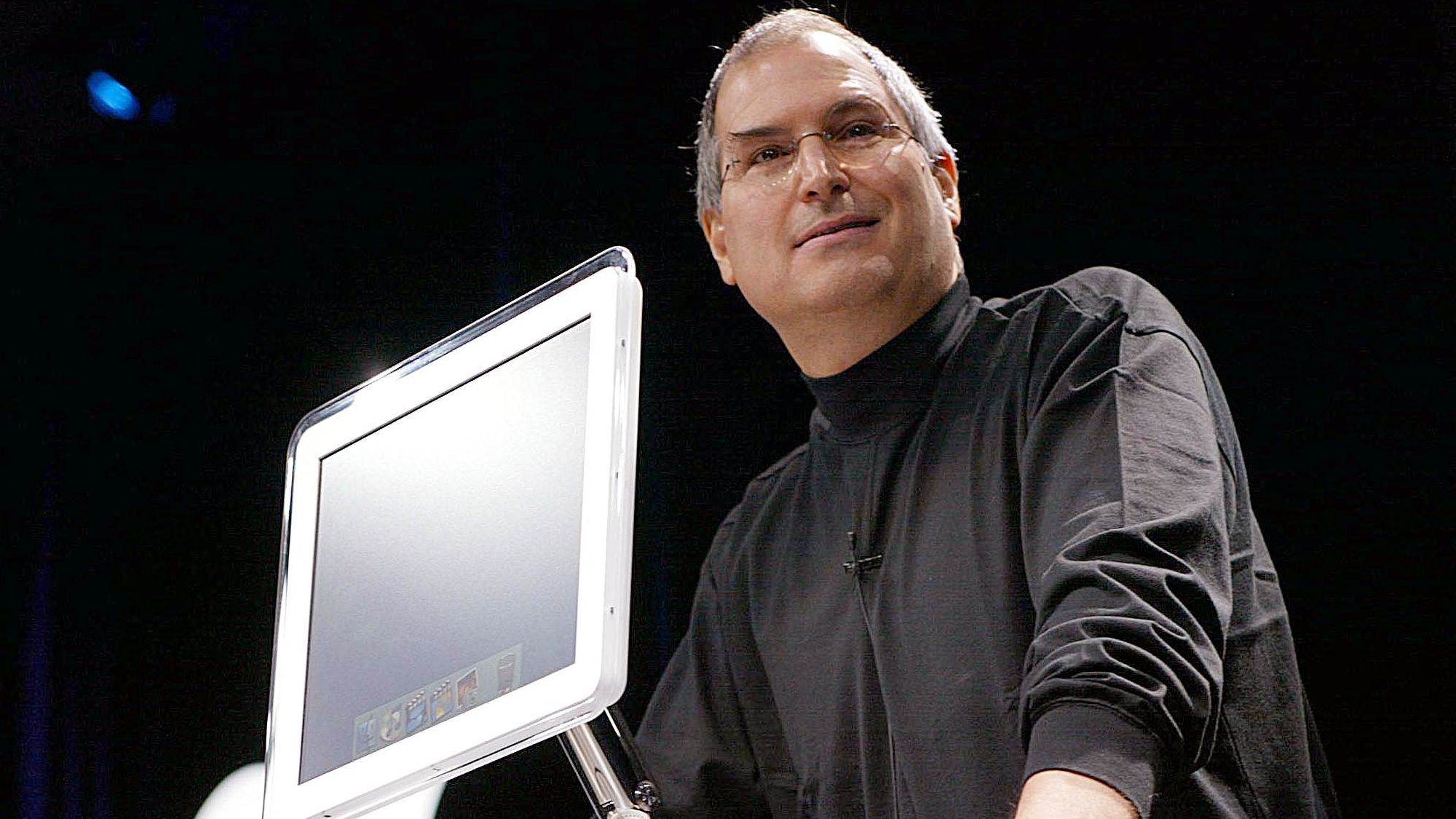 Apple Computer co-founder and CEO Steve Jobs introduces the all-new flat-panel iMac computer during his keynote speech at the MacWorld Expo in January 2002. 