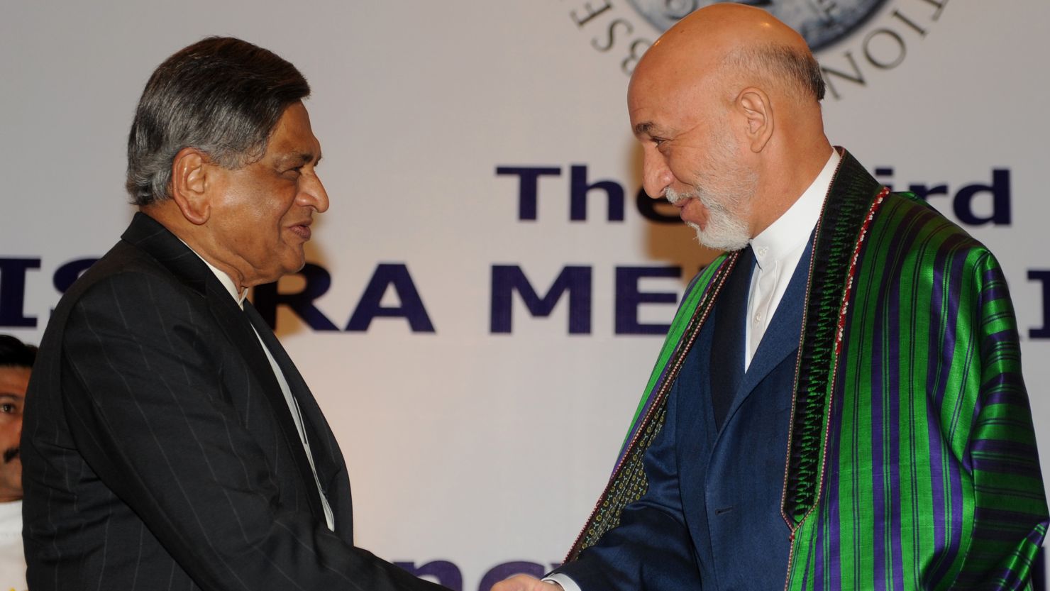 Afghan President Hamid Karzai, right, greets Indian Foreign Minister S.M. Krishna in New Delhi on Wednesday.