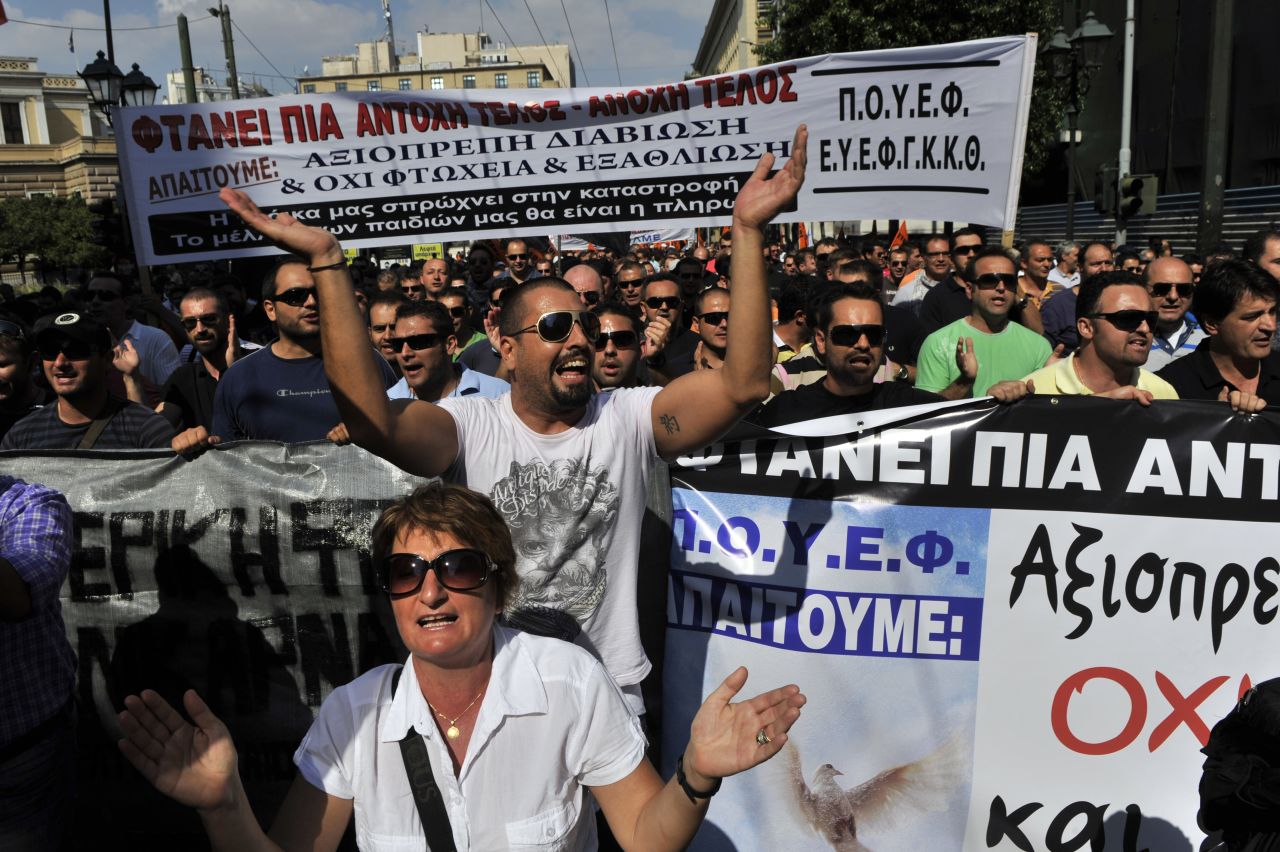 Protesters march toward the Greek Parliament shouting slogans against their government and the group overseeing Greece's $146 billion bailout: the European Central Bank, European Commission and International Monetary Fund.