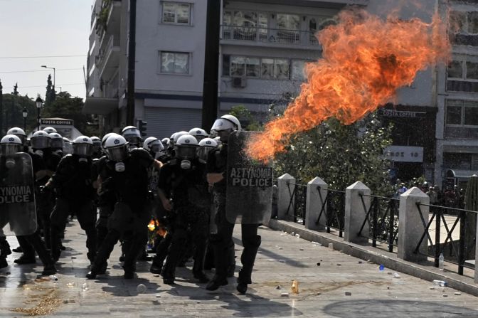 A molotov fire bomb explodes by police during a protest in front of the Greek Parliament in Athens on Wednesday, October 5. At least 10,000 marchers shut down the center of the Greek capital Wednesday to protest the latest waves of austerity measures announced by the government.
