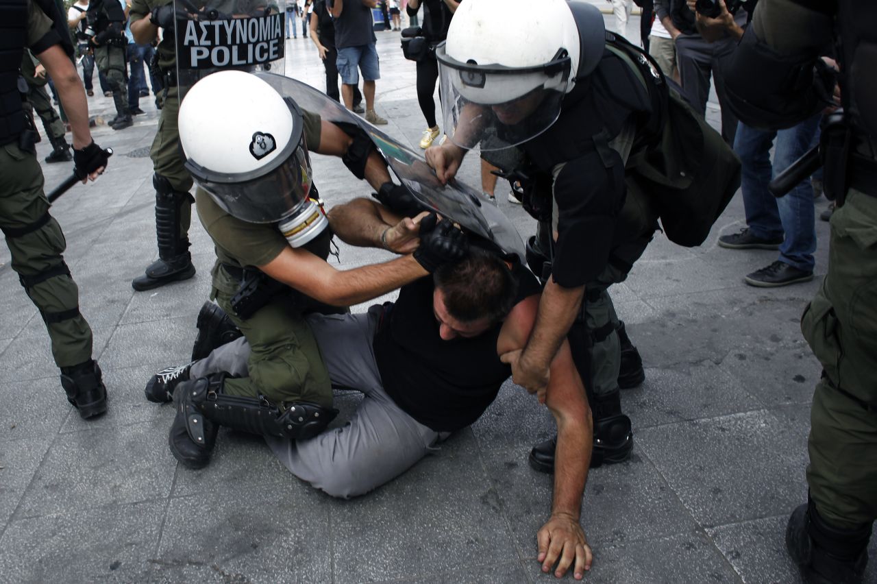 Police arrest a protester during Wednesday's rally in Athens.