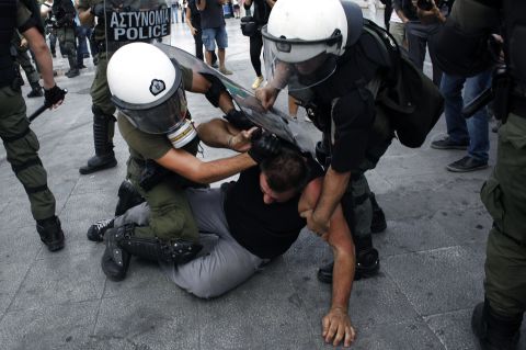 A demonstrator is arrested in Athens during a protest rally last October against austerity cuts imposed to tackle Greece's debt crisis