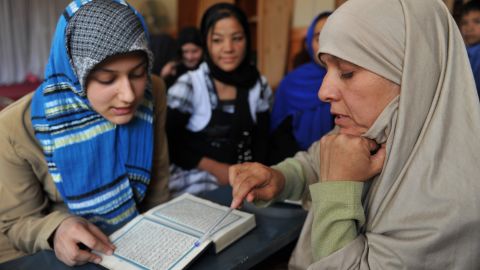Meher Afroza, right, teaches the Quran last month at an Islamic school in Kabul, Afghanistan.