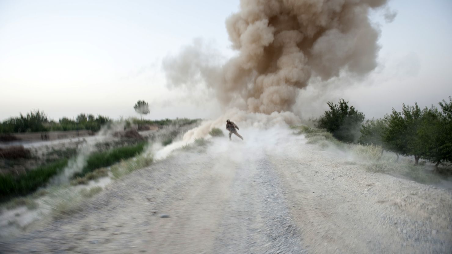 A U.S. Marine sergeant runs to safety as an IED explodes in Afghanistan's Helmand Province on July 13, 2009.