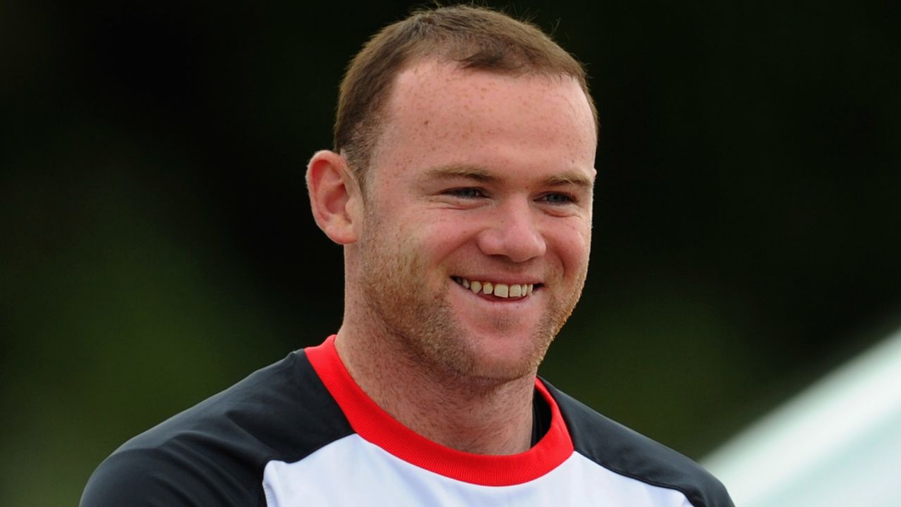 Wayne Rooney is all smiles in England training despite his father's arrest as part of a betting fraud probe.