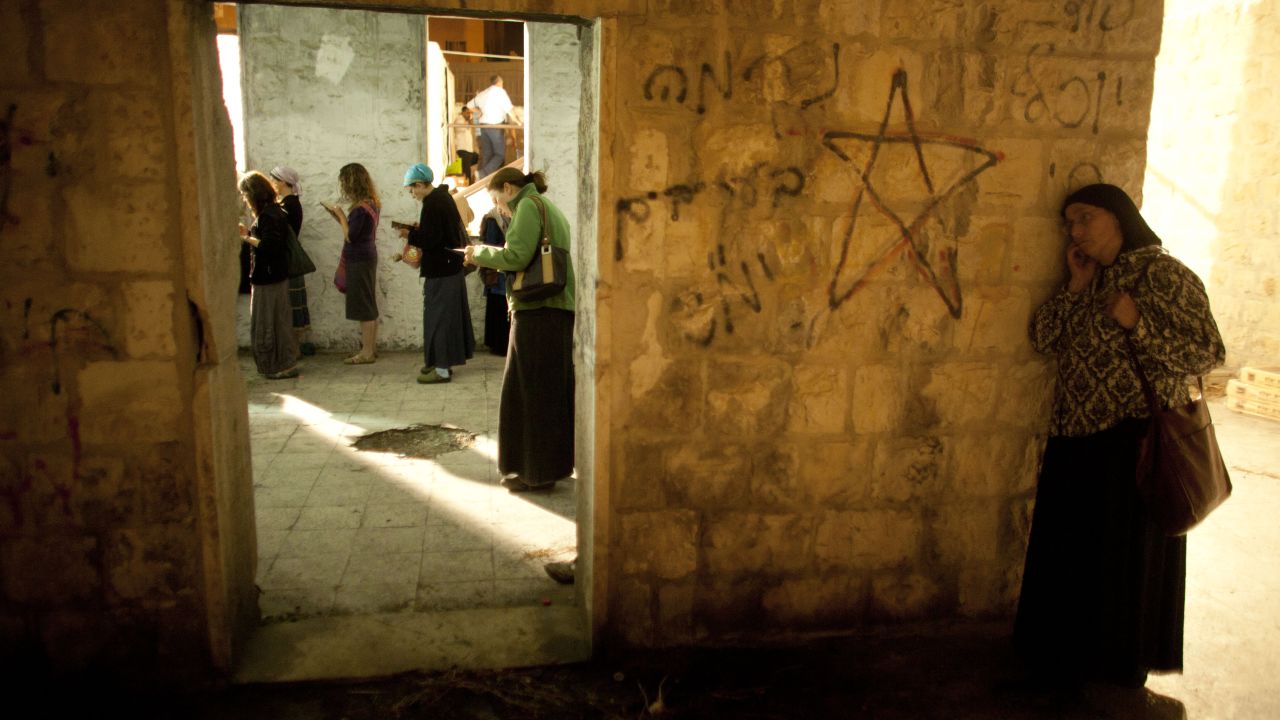 Jewish worshippers pray outside Joseph's Tomb on 4 July, in the northern West Bank city of Nablus.