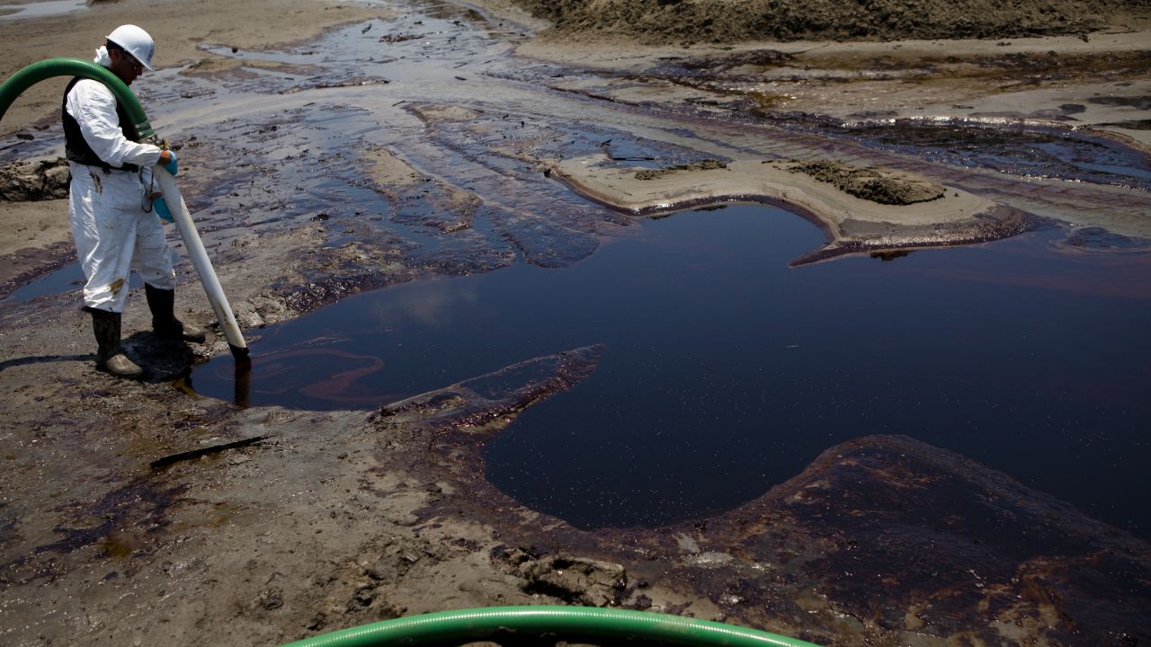 Crews suck up oil from the Deepwater Horizon disaster in Grand Isle, Louisiana, on June 9, 2010.