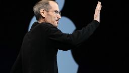Apple CEO Steve Jobs waves as he delivers the keynote address.