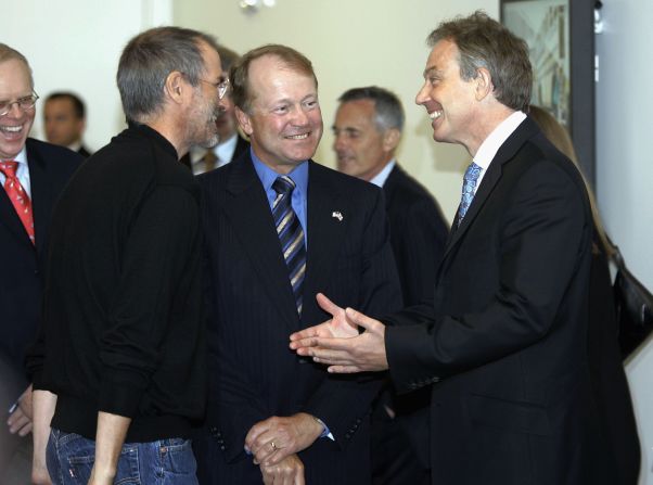British Prime Minister Tony Blair, right, talks with <a href="http://www.cnn.com/specials/tech/steve-jobs-the-man-in-the-machine">Jobs</a>, left, and Cisco Systems CEO John Chambers during a meeting of Silicon Valley executives at Cisco headquarters in July 2006. 