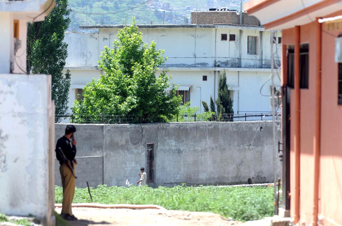 A Pakistani policeman stands guard in front of Osama bin Laden's former compound in Abbottabad on May 7, 2011.