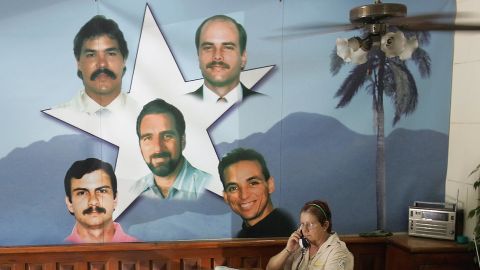 A government employee works next to a mural showing the Cuban Five in Havana in August 2005. Three of them remain imprisoned in the United States.