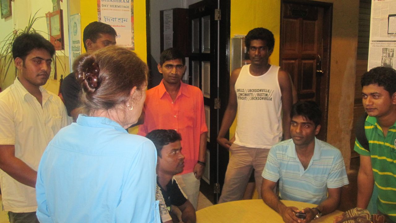 Debbie Fordyce talks with migrant workers seeking assistance through her Cuff Road Project.