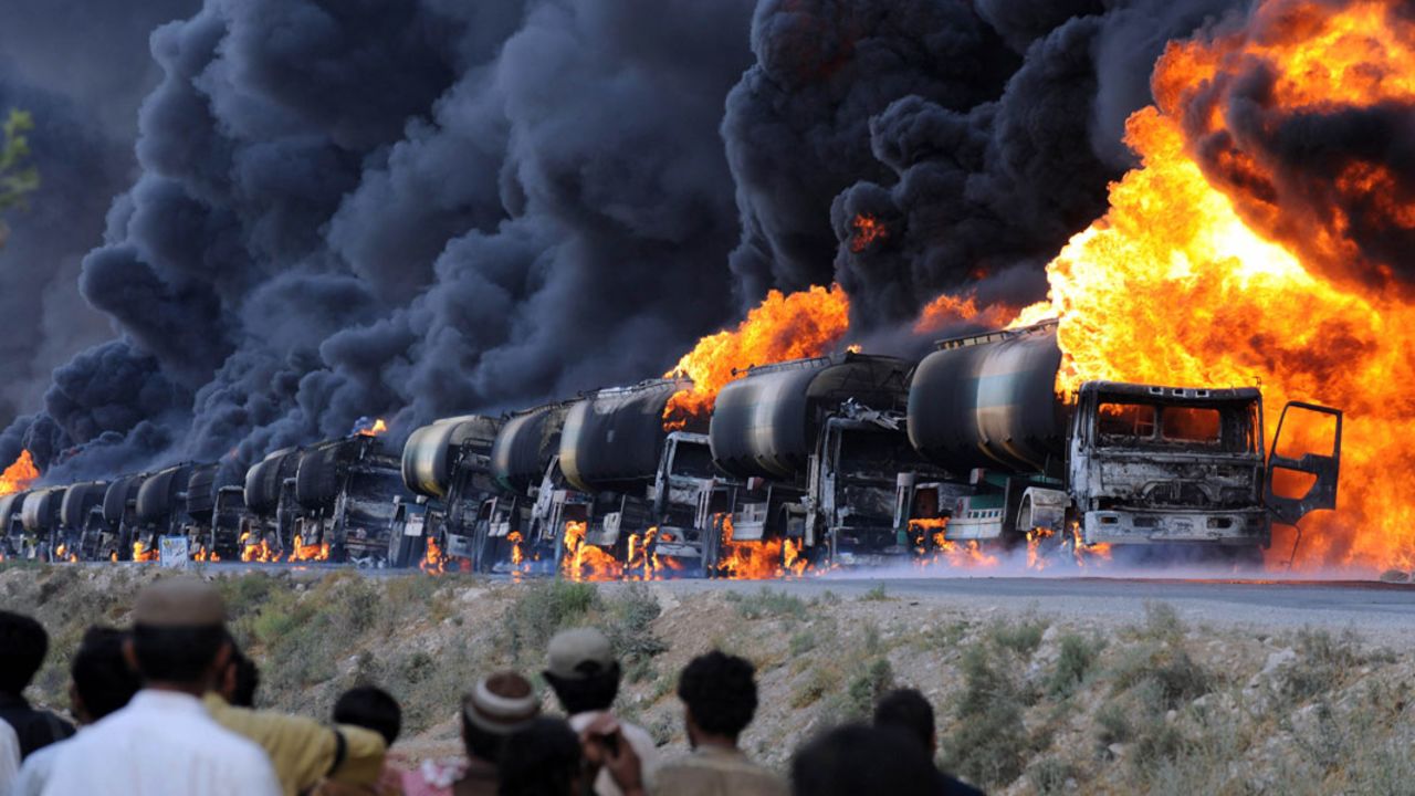 The burning remains of a NATO supply convoy symbolizes the immense threat from Taliban insurgents.