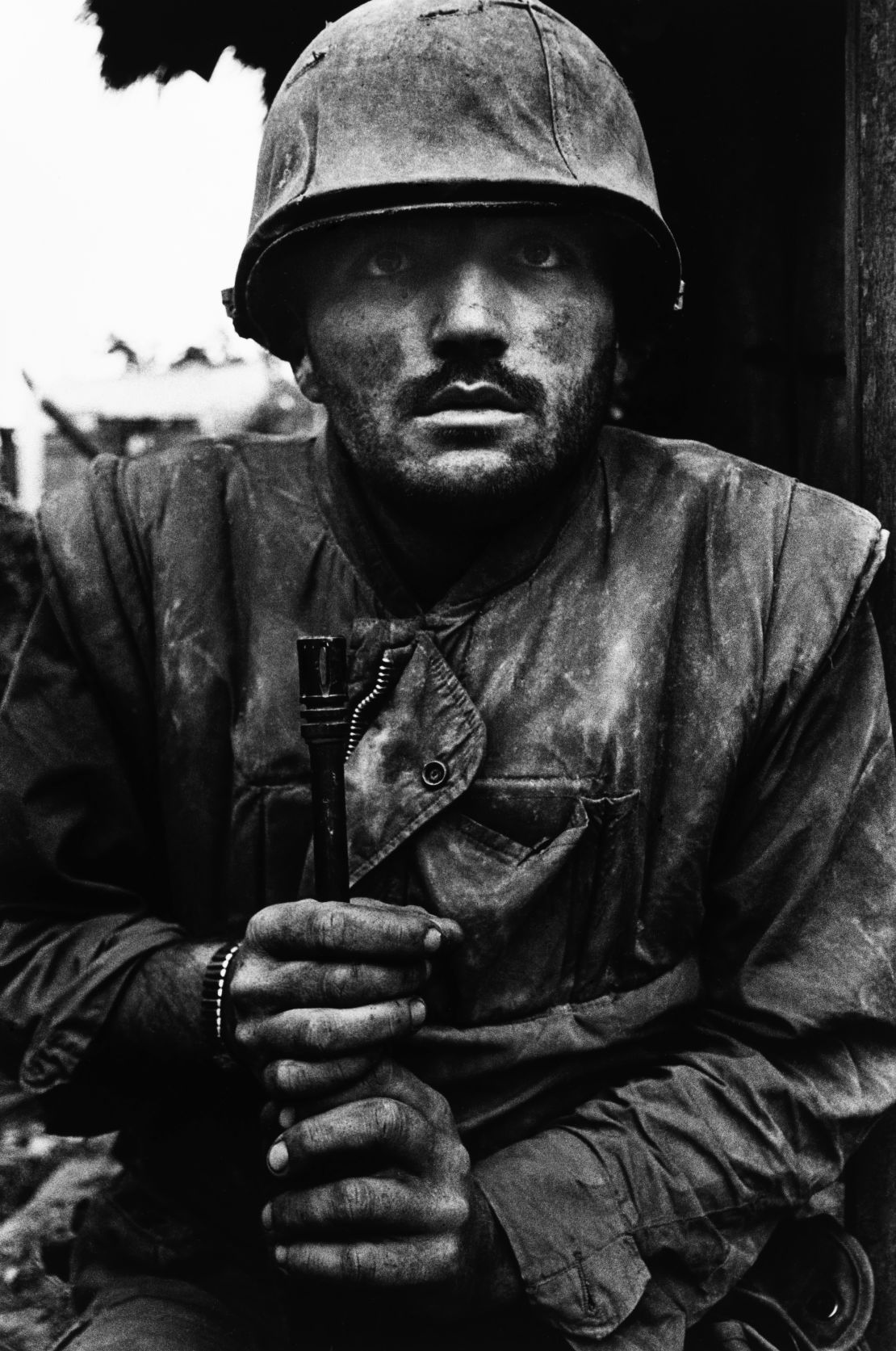 A U.S. Marine suffering from severe shell shock waits to be evacuated to safety during the Battle for Hue, Vietnam, 1968.