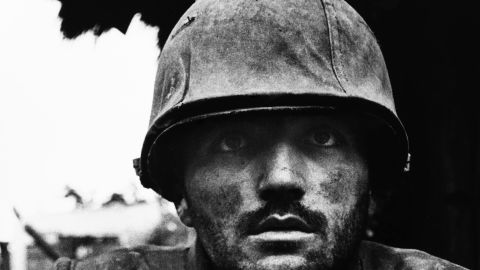 A U.S. Marine suffering from severe shell shock waits to be evacuated to safety during the Battle for Hue, Vietnam, 1968.