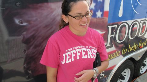 Milagros Escalaera, an Afghanistan war veteran, is helped by Rich Synek's mobile food pantry.