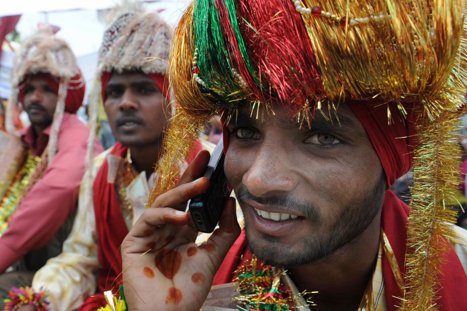 An Indian talks on his mobile phone during a mass marriage ceremony for some 525 poverty-stricken couples from the India-Pakistan border area  on April 13, 2009. 