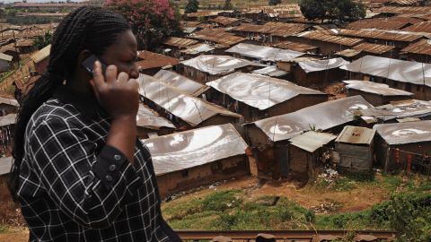 A woman speaks on a mobile phone in front of Kibera, one of the world's largest slums, on February 16, 2009, near Nairobi. Mobile phone growth in Africa has grown more than 400% from 2005 to 2010.