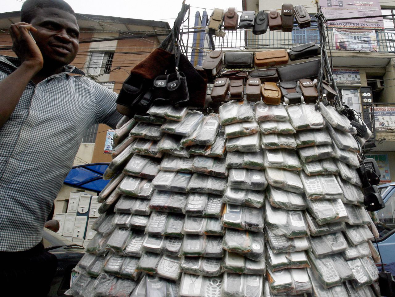 A vendor of mobile phones in Lagos, Nigeria, in April 2007. The cost of cell phones have dropped in the past decade, which saw mobile subscriptions grow to 4 billion in the developing world.