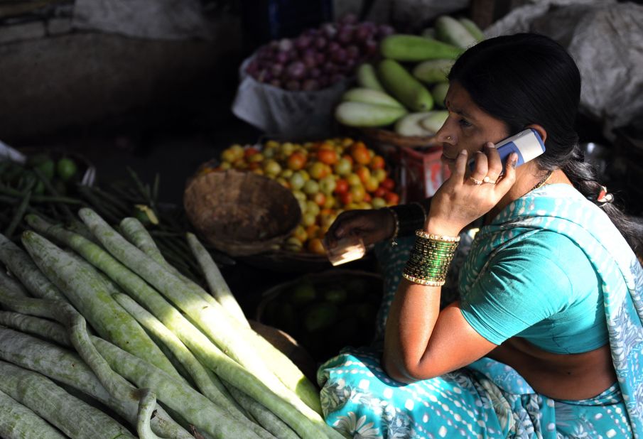 This April 17, 2009 shows an Indian vendor using her mobile phone to take customers orders at a wholesale market on the outskirts of Hyderabad. The simple ability to make a phone call has had far-reaching economic consequences, analysts say.
