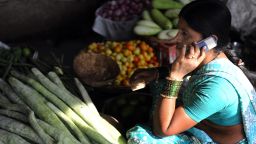 This April 17, 2009 shows an Indian vendor using her mobile phone to take customers orders at a wholesale market on the outskirts of Hyderabad. On May 22, 2011 experts reported that hundreds of millions of poor Indians who have no access to financial services could benefit from mobile banking, as cell phone use grows at breakneck pace.