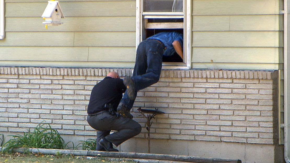 Kansas City police seach the Irwin family home on Sunday.
