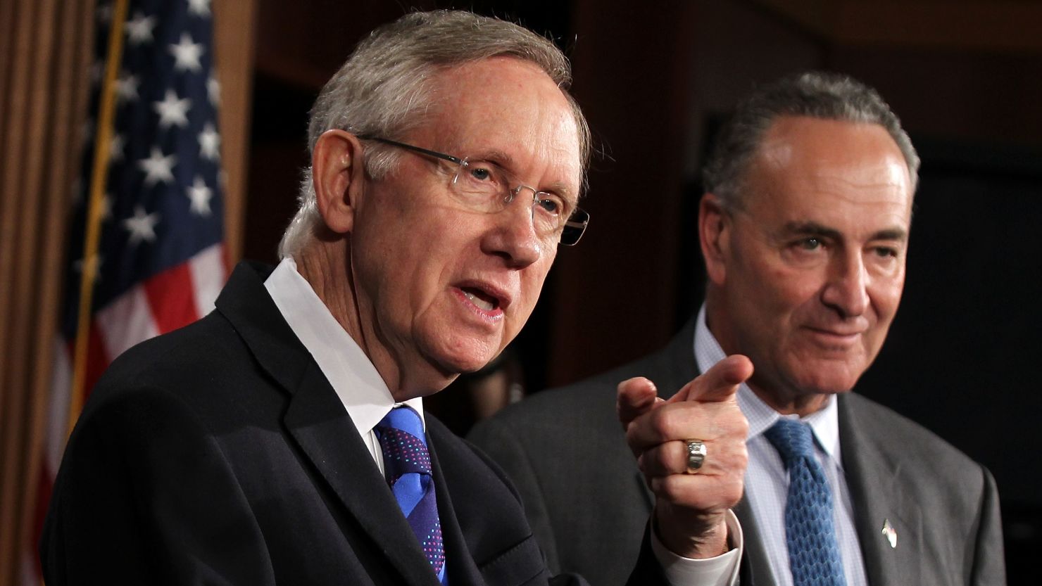 Sens. Harry Reid, left, and Charles Schumer are backing a surtax on the income of people who earn more than $1 million.