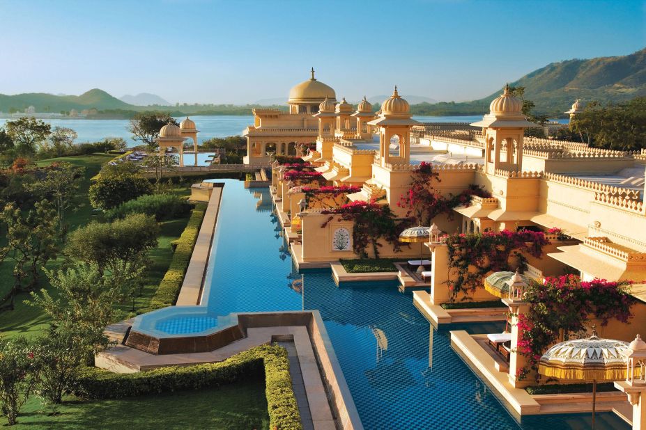 The Oberoi Udaivilas at Udaipur is built in the style of a traditional Indian palace, with gold-leaf domes and sand-colored walls reflected in the waters of Lake Pichola and the hotel's pools.
