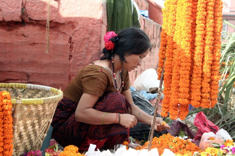 Barry Wenlock lives in Kathmandu and has led many treks through the Himalayas. He shared photos taken during the 15-day Dasain festival, the country's largest event. In this photo, a young woman is stringing marigold flowers in Durbar Square to get ready for the annual traditional event. The festival ran from September 28 to October 11 this year. Each day has a special name and theme. Wenlock noted that the seventh day of the festival, known as Fulpati, features celebrations of the military including marches and blessings of vehicles.