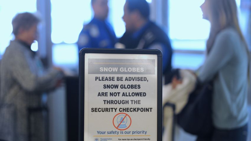 Passengers wait to clear security at  La Guardia Airport in New York, fully warned about snow globes.