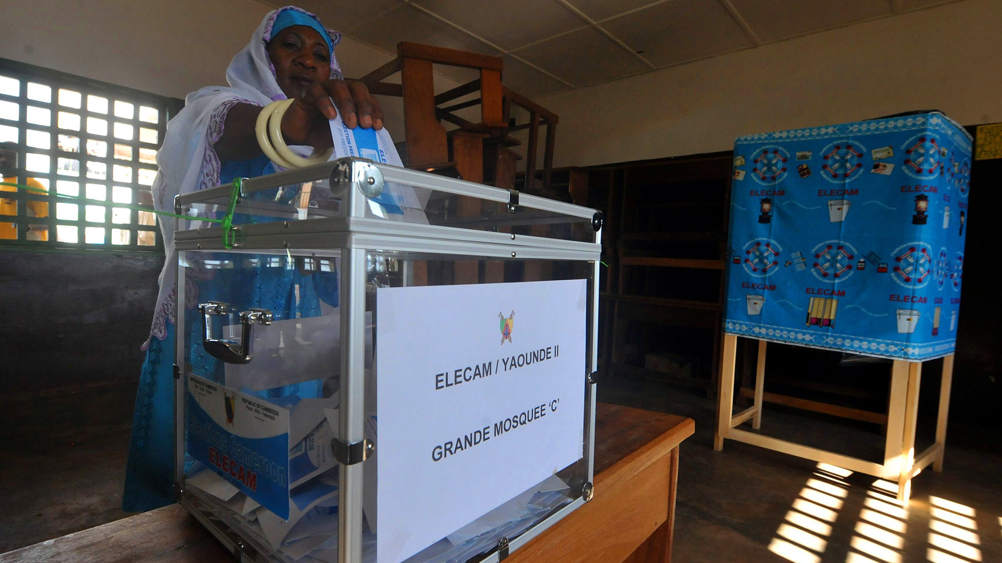 A Cameroonian casts her vote at a polling station in Yaounde on October 9.