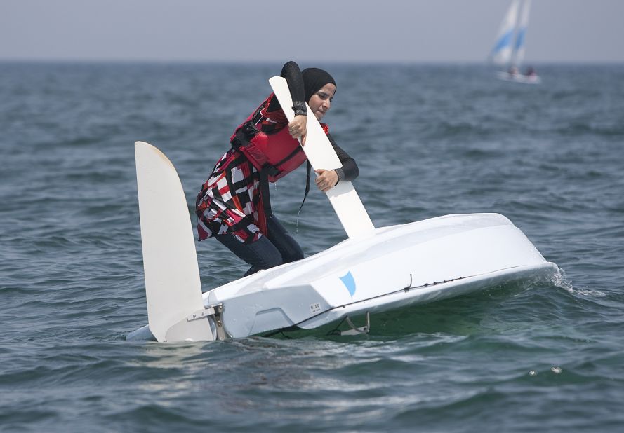 As her boat capsizes during training, a particpant of the programme tries to turn it around. 