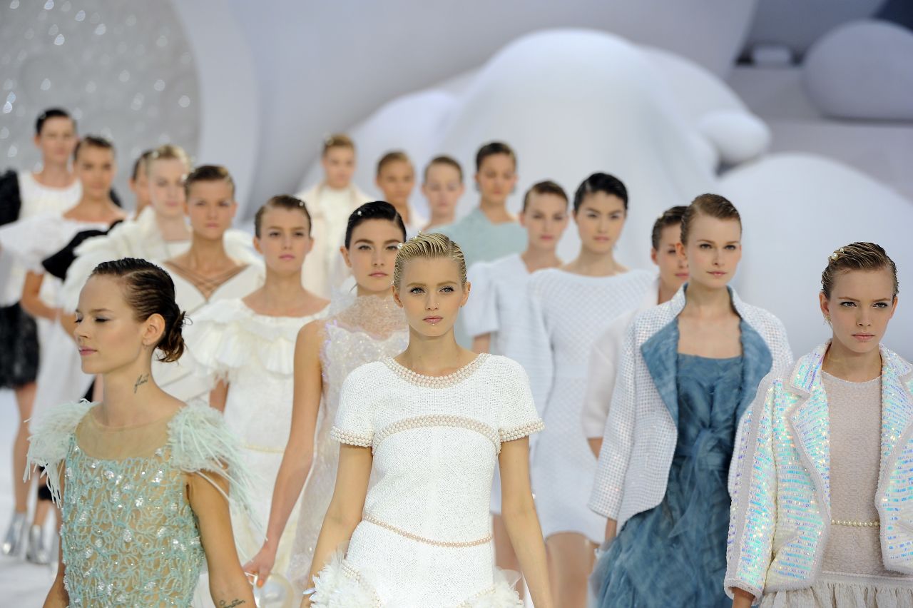 Fashion will be frothy, frilly and feminine next season. Models walk the runway during the Chanel Ready-to-Wear Spring/Summer 2012 show during Paris Fashion Week at the Grand Palais.