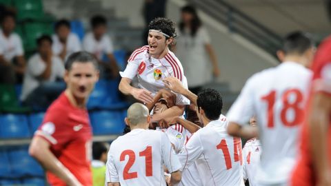 Delighted Jordan players celebrate a goal in their 3-0 win in Singapore 