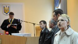 Yulia Tymoshenko addresses Ukrainians while a judge of the Kiev Pechersky court reads a verdict to her during the sittings in Kiev on October 11, 2011.