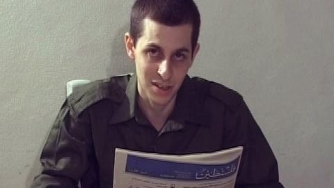 In a Hamas video, Israeli soldier Gilad Shalit is seen holding a Palestinian newspaper.