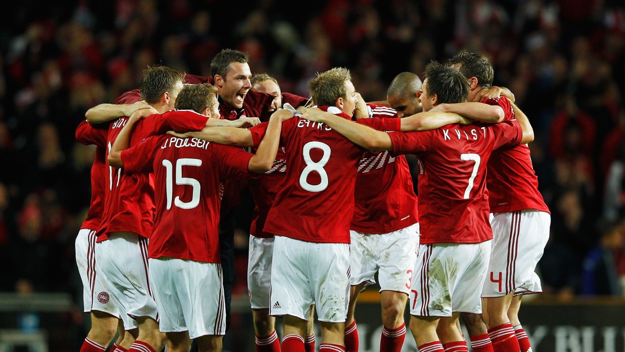Denmark's players celebrate their 2-1 home win over Portugal to book their place in Euro 2012
