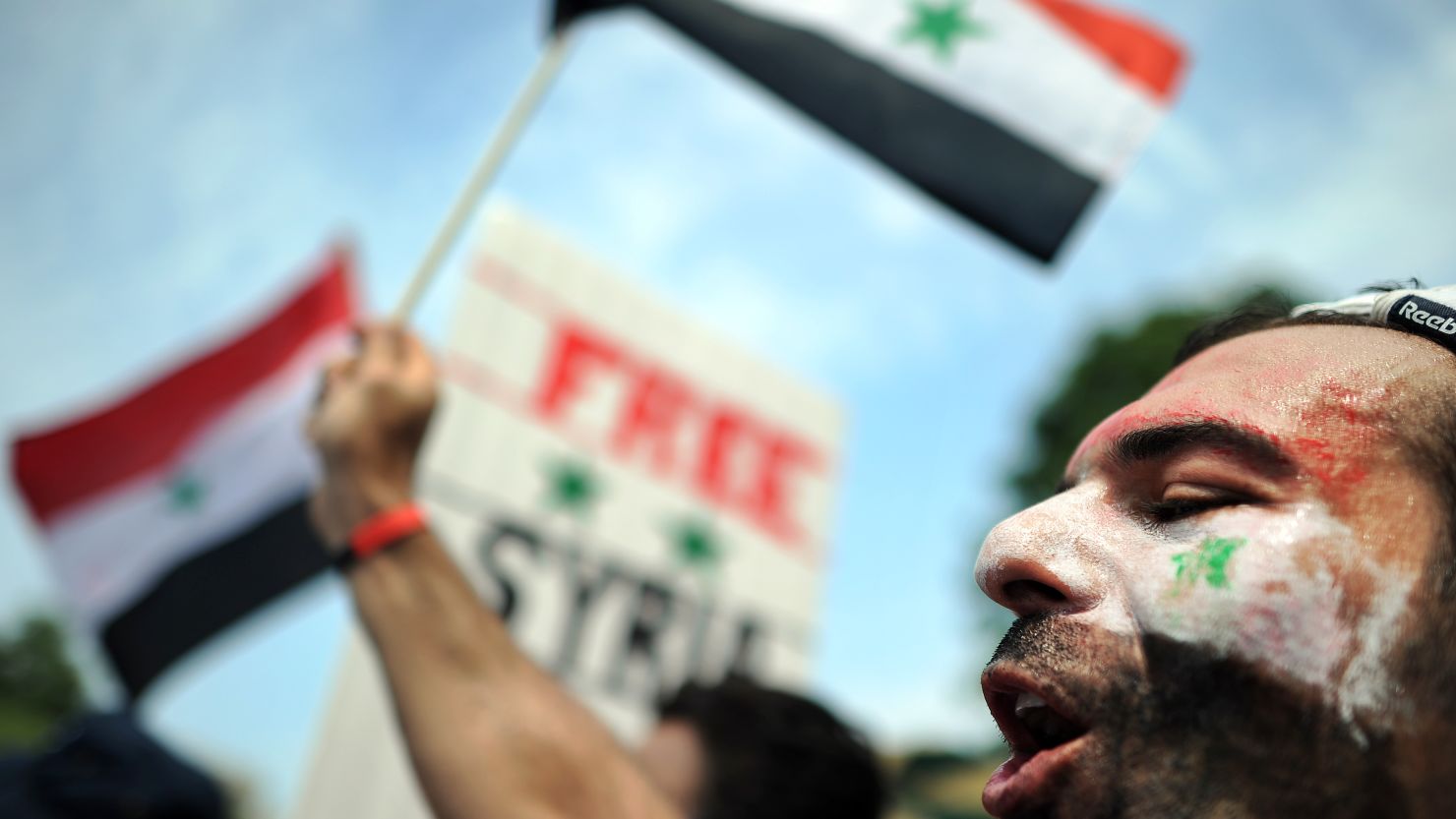 A man shouts slogans against the Syrian government in front of the White House in Washington, DC, on July 23, 2011.