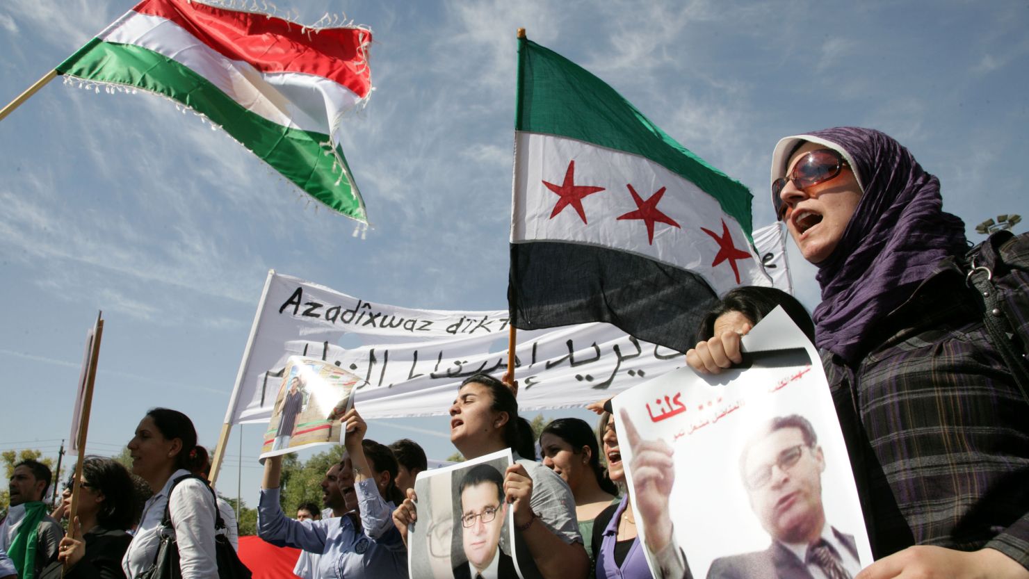 Kurdish protestors hold pictures of Meshaal Tamo at a demonstation in Arbil, northern Iraq, on October 8, 2011.