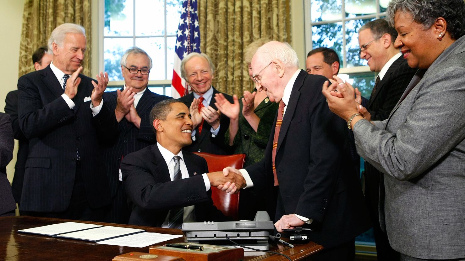 President Barack Obama shakes hands with gay rights activist Frank Kameny in June 2009 after signing a memorandum to extend benefits to same-sex partners of federal employees.
