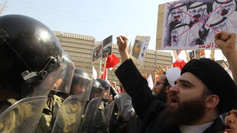 Iranian clerics hold up anti-Saudi placards as they face riot policemen in front of the Saudi embassy in Tehran earlier this year.