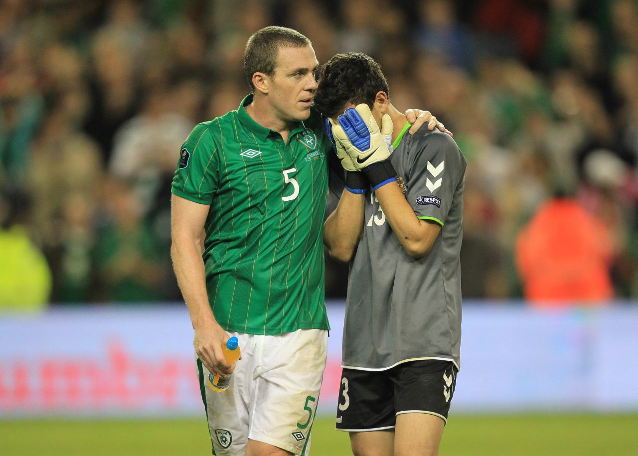 Ireland will also be seeded for the playoffs, which will take place over two legs in November, after a 2-1 victory over Armenia in a winner-takes-all match in Dublin. Defender Richard Dunne (left) scored Ireland's second and winning goal, before consoling Armenia's substitute goalkeeper Armenak Petrosyan at the final whistle.